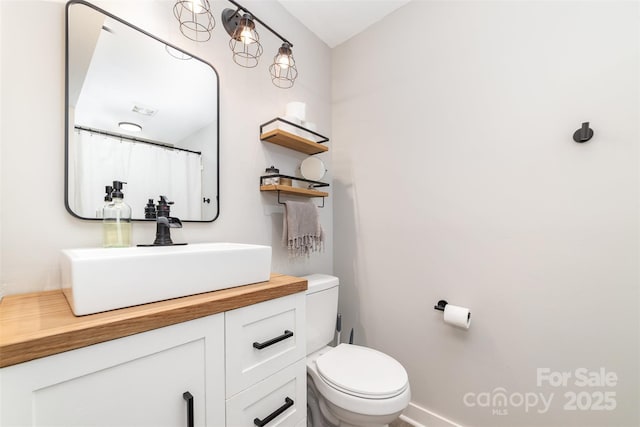 bathroom with toilet and vanity