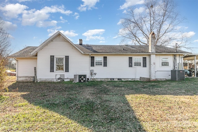 rear view of house with a yard and central air condition unit