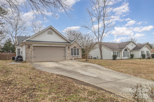 ranch-style home with a front yard, a garage, and central AC unit