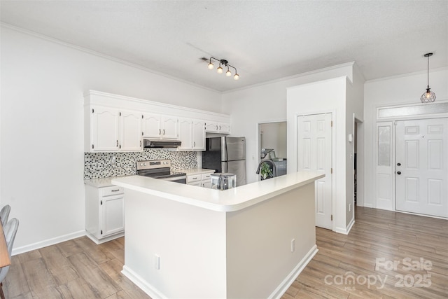 kitchen with appliances with stainless steel finishes, a center island, white cabinets, and decorative light fixtures