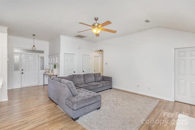 living room featuring ceiling fan, vaulted ceiling, ornamental molding, and light hardwood / wood-style flooring