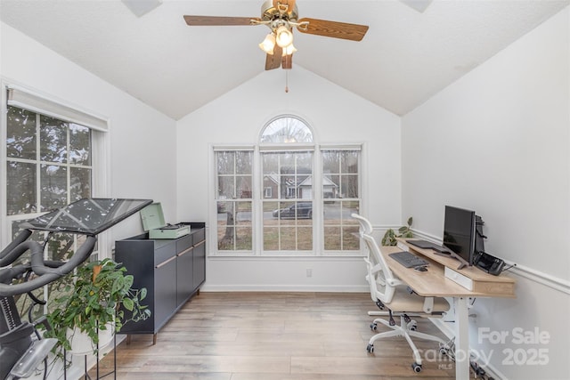 office space with lofted ceiling, ceiling fan, and light hardwood / wood-style floors