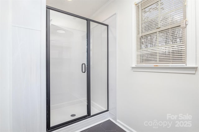 bathroom with walk in shower, tile patterned floors, and ornamental molding