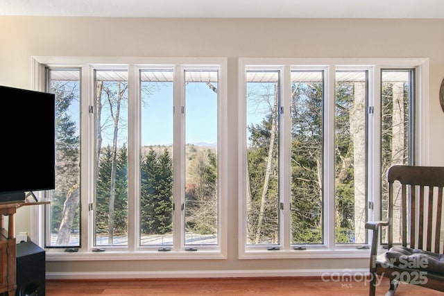 doorway to outside with hardwood / wood-style flooring and plenty of natural light