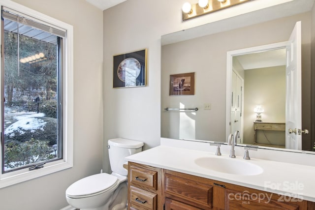 bathroom featuring toilet and vanity