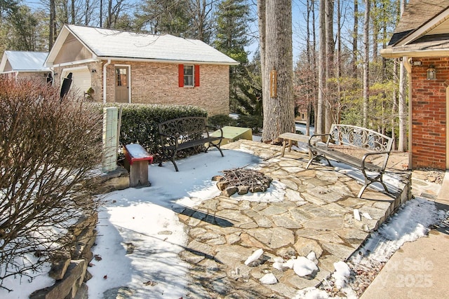 exterior space featuring an outdoor fire pit and a garage