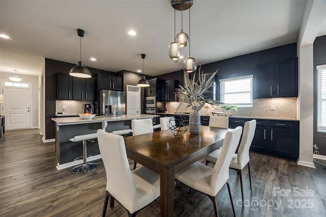 dining space with dark hardwood / wood-style flooring