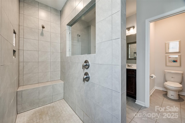 bathroom with toilet, a tile shower, tile patterned floors, and vanity