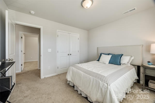 bedroom featuring a closet and light colored carpet