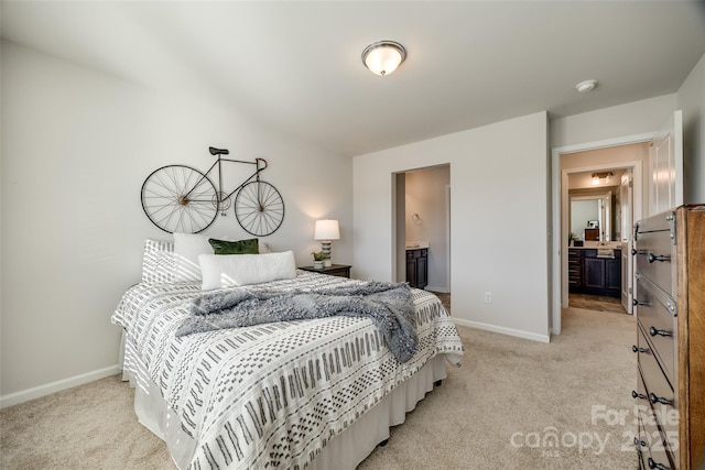 bedroom with light colored carpet and connected bathroom