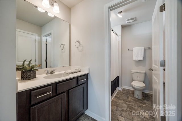 bathroom with toilet and vanity