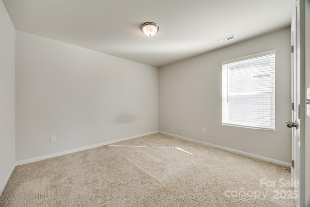 carpeted spare room featuring plenty of natural light