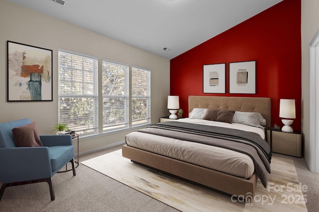 carpeted bedroom with lofted ceiling