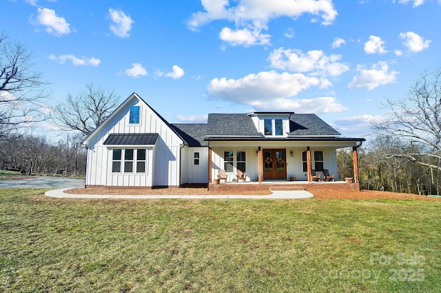 modern farmhouse featuring covered porch and a front lawn