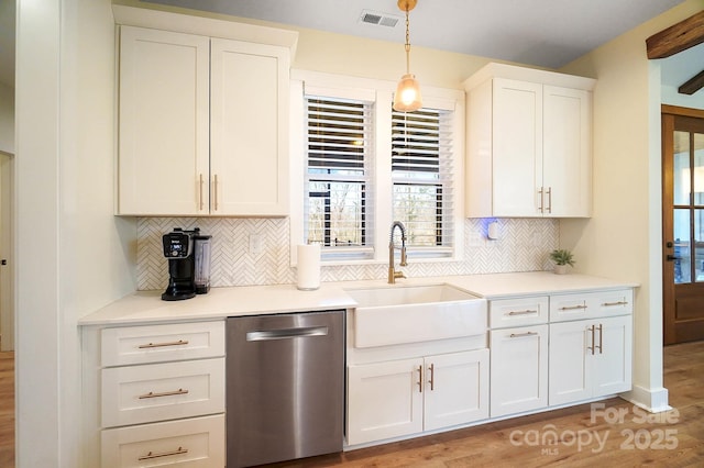 kitchen featuring white cabinetry, dishwasher, sink, tasteful backsplash, and pendant lighting