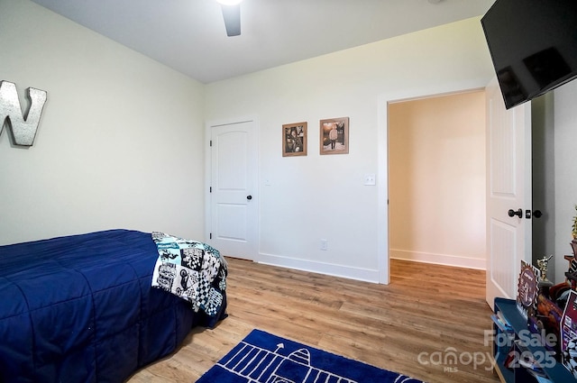 bedroom with ceiling fan and hardwood / wood-style flooring