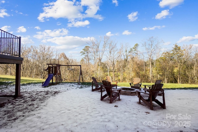 exterior space featuring a playground and a fire pit