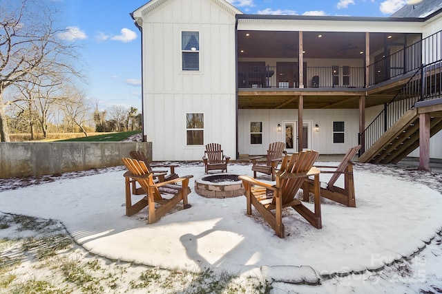 snow covered property featuring an outdoor fire pit