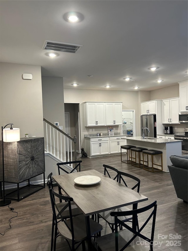 dining space with dark hardwood / wood-style floors