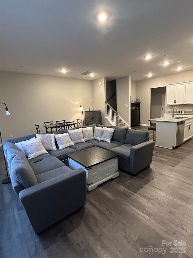 living room with dark hardwood / wood-style floors and sink