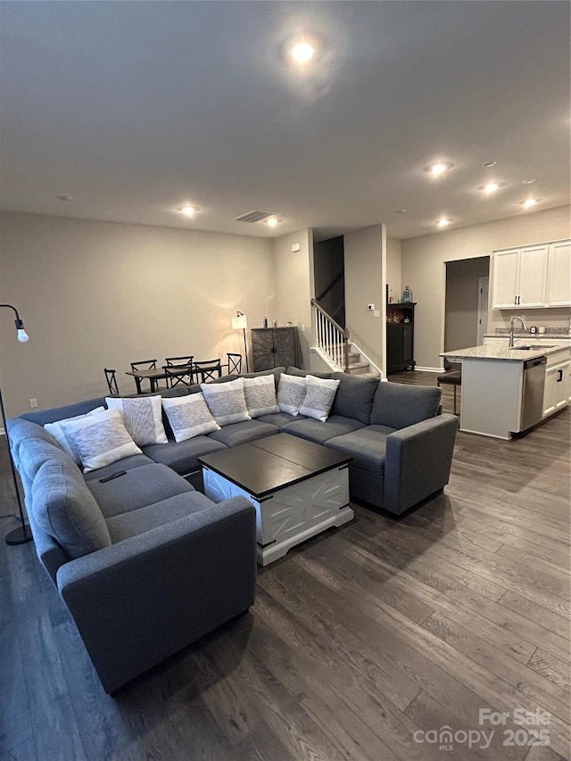 living room with dark hardwood / wood-style flooring and sink