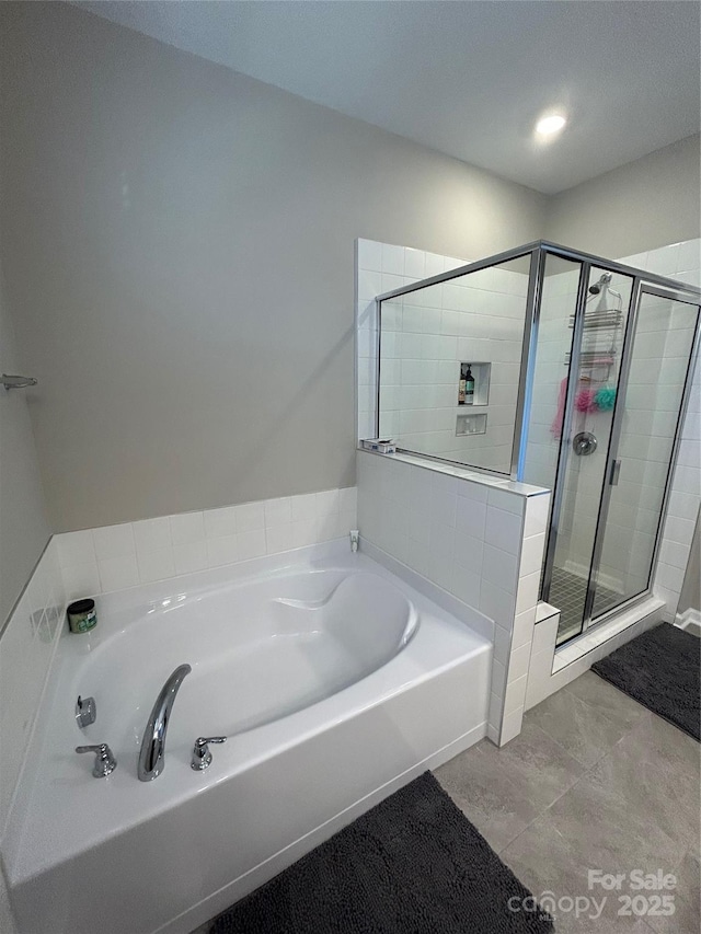 bathroom featuring separate shower and tub and tile patterned flooring