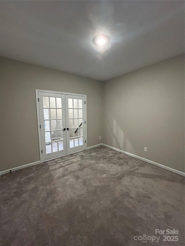 unfurnished room with french doors and dark colored carpet