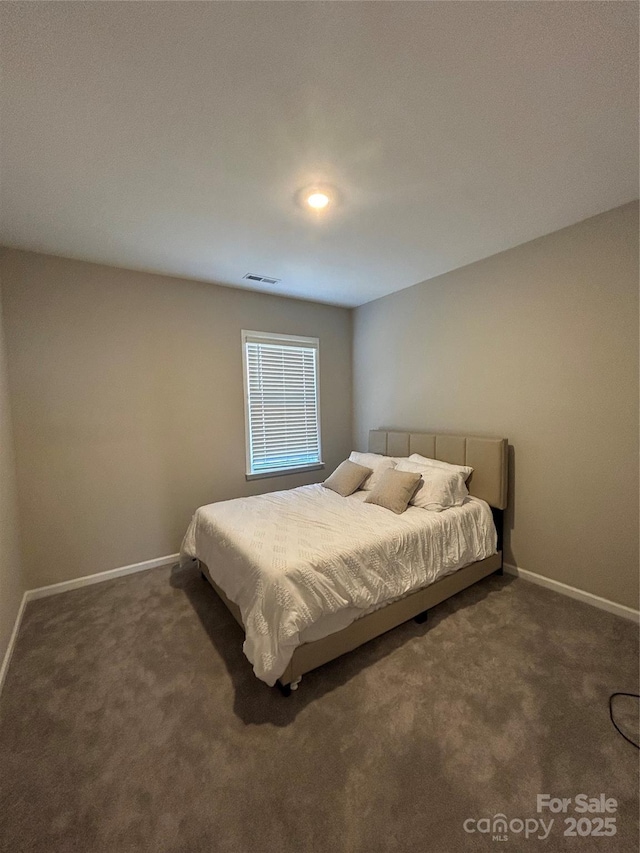 bedroom with dark carpet