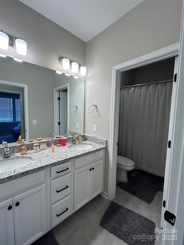 bathroom featuring toilet, tile patterned flooring, and vanity