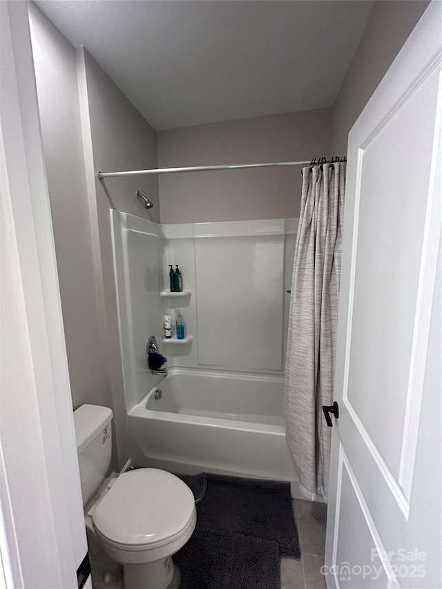 bathroom featuring toilet and tile patterned flooring