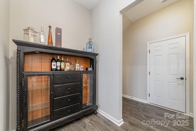 bar with dark wood-type flooring