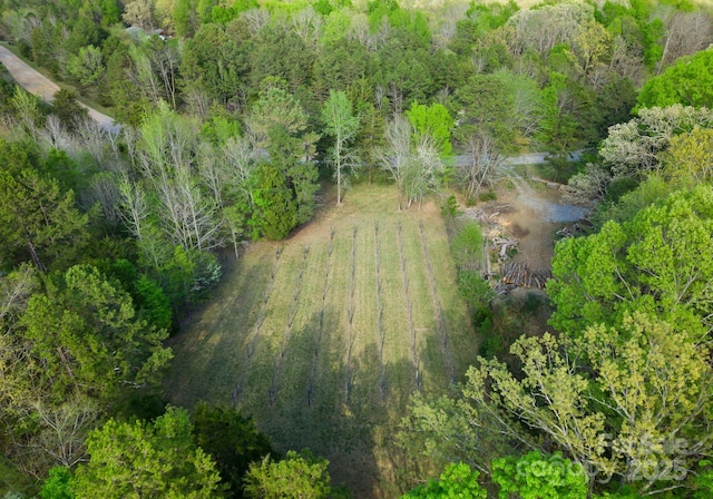 birds eye view of property with a view of trees