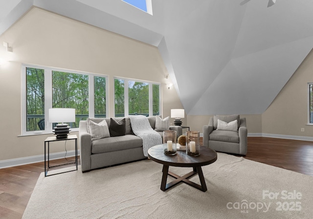 living area featuring a healthy amount of sunlight, baseboards, and wood finished floors