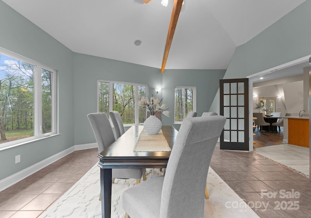 tiled dining space with french doors, baseboards, a ceiling fan, and vaulted ceiling