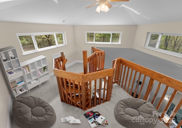 staircase featuring carpet flooring, baseboards, vaulted ceiling, and ceiling fan