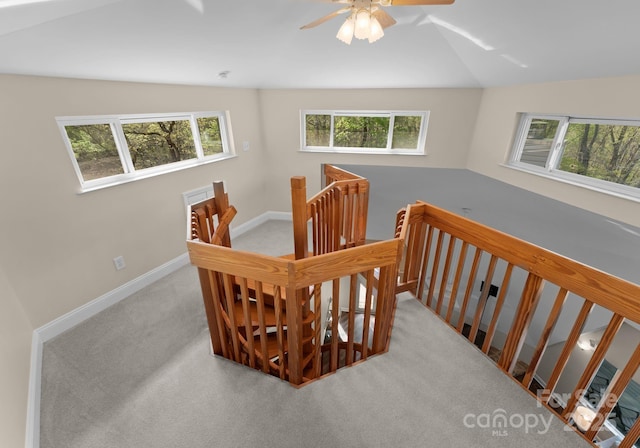 stairway with carpet, baseboards, vaulted ceiling, and ceiling fan