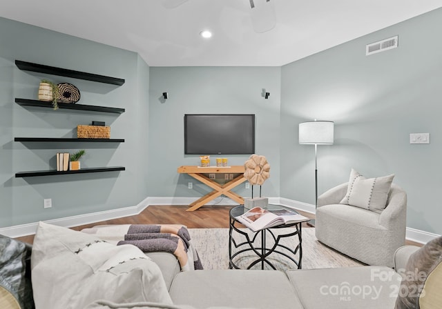 living room with wood finished floors, baseboards, visible vents, and recessed lighting