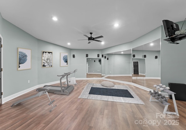 workout area featuring ceiling fan, recessed lighting, light wood-style floors, and baseboards