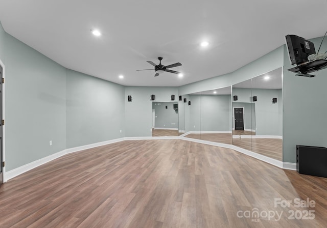 unfurnished living room featuring wood finished floors, ceiling fan, baseboards, and recessed lighting