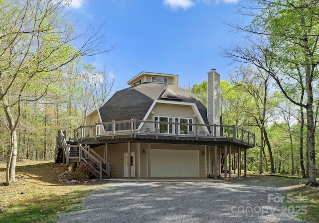 view of front of property featuring a chimney, a shingled roof, driveway, and stairs