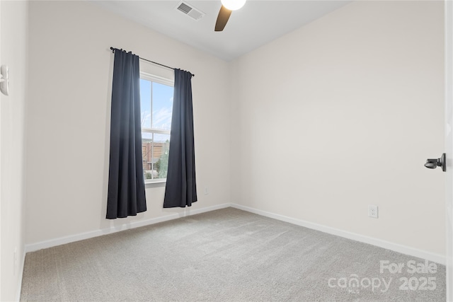 carpeted spare room featuring ceiling fan