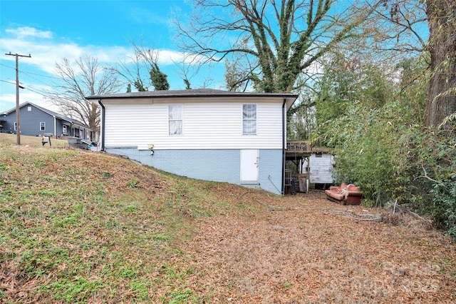 view of home's exterior featuring a wooden deck