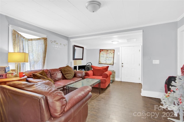 living room featuring dark hardwood / wood-style floors and ornamental molding