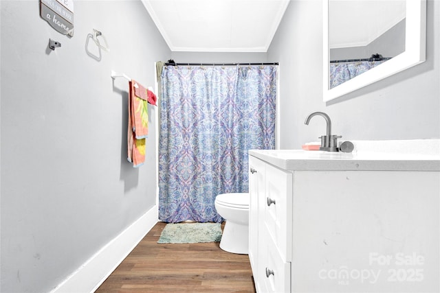 bathroom with vanity, hardwood / wood-style flooring, toilet, and ornamental molding