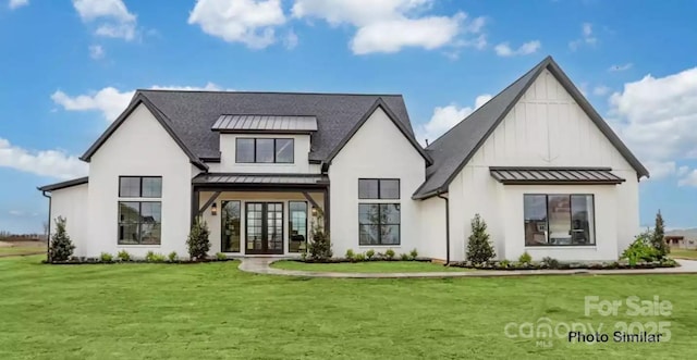 back of house featuring a lawn and french doors