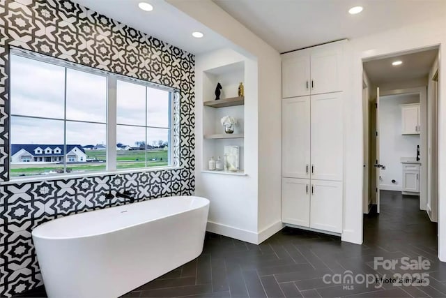 bathroom with built in features, a bath, and tile patterned flooring