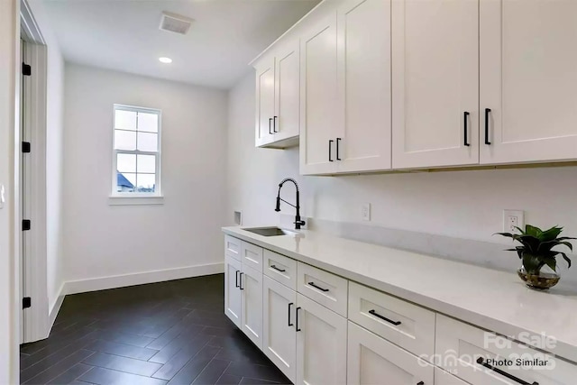 kitchen with white cabinets and sink