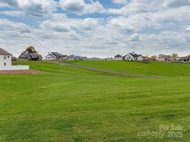 view of home's community featuring a yard