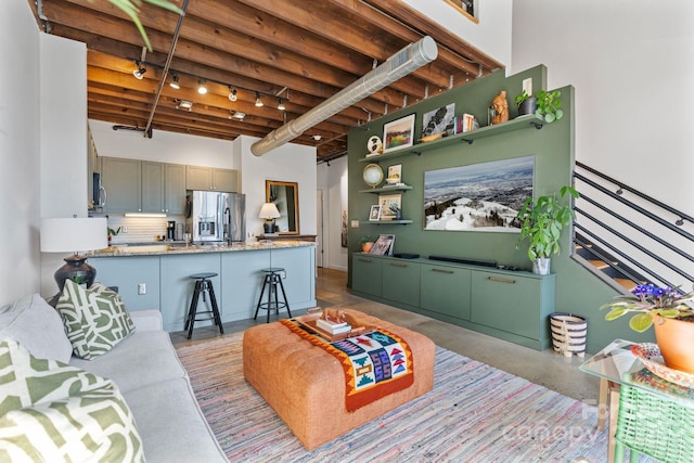 living room featuring beam ceiling