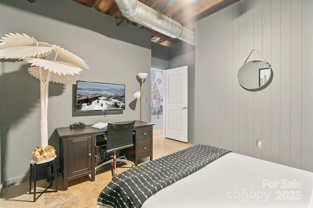 bedroom featuring wood walls